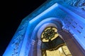 Details of the external facade of The Sheikh Zayed Grand Mosque illuminated with blue light in the evening