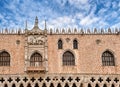 Details of facade of Doge's palace or Palazzo Ducale, Venice, Italy. Balcony with figures of Doge and Lion of St Mark Royalty Free Stock Photo