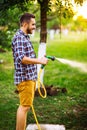 Close up details of gardener using hosepipe and watering the lawn, grass and plants. backyard gardening Royalty Free Stock Photo