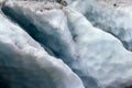 Details of glacier glacier cleaves in bright blue light