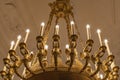 Details of a golden chandelier with many angels holding candles in the Royal Palace Noordeinde, The Hague, Netherlands