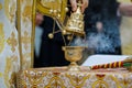 Details with a golden metallic christian orthodox frankincense burner, or censer