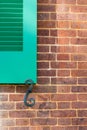Details of green window shutters and holder on brick wall Royalty Free Stock Photo