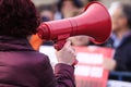 Details with the hand of a woman holding a megaphone