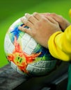 Details with the hands of a boy on an Adidas Conext 19 European qualifiers official soccer match ball