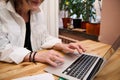 Details of the hands of a fashion designer, entrepreneur small business owner working on laptop at workplace Royalty Free Stock Photo