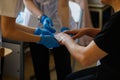 Details with the hands of a female medic and a female resident medic checking the dermatological health of a woman