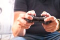 Details of hands of a man holding a video console controller, the man is playing video games. Concept video games