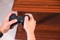 Details of hands of a man holding a video console controller, the man is playing video games. Concept video games