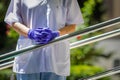 Details with the hands of a woman medic leaning patiently on a metal rail