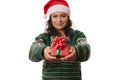 Details: happy Christmas present in the hands of blurred pretty woman wearing Santa hat and green Xmas patterned sweater