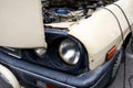 Details with the headlight and the open hood of a Romanian vintage Dacia 1300 car