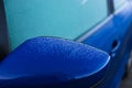 Details of iced car rearview mirror during a cold winter morning, dangerous road conditions Royalty Free Stock Photo