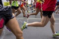 Details of the legs of people running through the streets