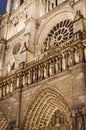 Details of the magnificent facade of the Parisian architectural cathedral Notre Dame de Paris by night Royalty Free Stock Photo