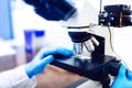 Details of medical laboratory, scientist hands using microscope for chemistry. Engineer Testing samples