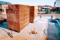 Details of modern bricks on construction site. Piles of bricks on concrete slab