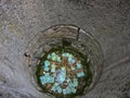 Details with money thrown inside a medieval well at Bran Castle, known also as DraculaÃ¢â¬â¢s Castle in Transylvania, Romania