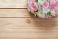 Details of the morning of the wedding day. two gold wedding rings are on the brown wood table Royalty Free Stock Photo