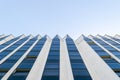 Details of office building exterior. Business buildings skyline looking up with blue sky. Modern architecture apartment. High tech Royalty Free Stock Photo