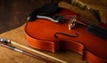 Details of an old and beautiful violin on a rustic wooden surface and black background, low key portrait, selective focus Royalty Free Stock Photo