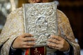 Details of an Orthodox priest reading from the Holy Bible during an Orthodox Baptism