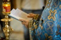 Details of an Orthodox priest reading from the Holy Bible during an Orthodox Baptism