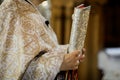 Details of an Orthodox priest reading from the Holy Bible during an Orthodox Baptism
