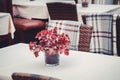 Details of outdoors cafe in Tallinn, Estonia. Bouquet of leaves on table.