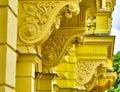 Details of parts of a facade of a residential building renovated in striking bright yellow in Marienbad