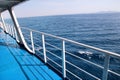 Details of passenger boat. Cruise ship deck. Picturesque view from ship deck on navy blue sea, horizon and sky during vacation. Royalty Free Stock Photo