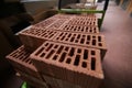 Details of a pile of stacked clay bricks with holes