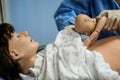 Details with plastic dummies representing a woman and her newly born baby used by medics and midwives for childbirth practice