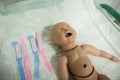 Details with a plastic dummy representing a newly born baby used by medics and midwives for childbirth practice