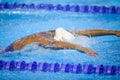 Details with a professional female athlete swimming in an olympic swimming pool