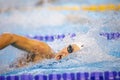 Details with a professional female athlete swimming in an olympic swimming pool