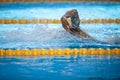 Details with a professional male athlete swimming in an olympic swimming pool freestyle