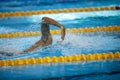 Details with a professional male athlete swimming in an olympic swimming pool freestyle