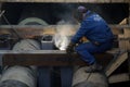 Details with a professional welder welding an industrial metallic pipeline