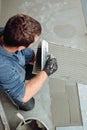 Details of worker installing ceramic tiles Royalty Free Stock Photo