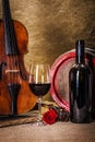 Red wine in glass, barell and violin Royalty Free Stock Photo