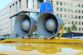 Details of retro police car with a megaphone and flashing blue siren light mounted on yellow top. Royalty Free Stock Photo