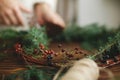 Details of rustic christmas wreath on wooden background, holiday advent