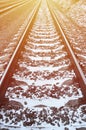 Details snowy Russian winter railway under bright sunlight. The rails and sleepers under the December snow. Russian Railways in d