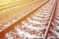 Details snowy Russian winter railway under bright sunlight. The rails and sleepers under the December snow. Russian Railways in d