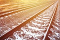 Details snowy Russian winter railway under bright sunlight. The rails and sleepers under the December snow. Russian Railways in d