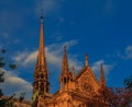 Details of the southern facade of Notre Dame de Paris Cathedral facade with the rose window and ornate spires in the warm light of