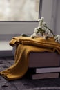 Details of still life in the home interior. Sweater, cup, wool, cozy, book, candle. Moody. Cosy autumn winter concept. Royalty Free Stock Photo