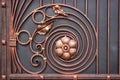 Details of the structure and decoration wrought iron gate. Vintage metal copper color pictures. Decorative scroll and Royalty Free Stock Photo