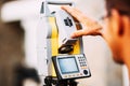 Details of survey engineer working with total station theodolite at landscaping project Royalty Free Stock Photo